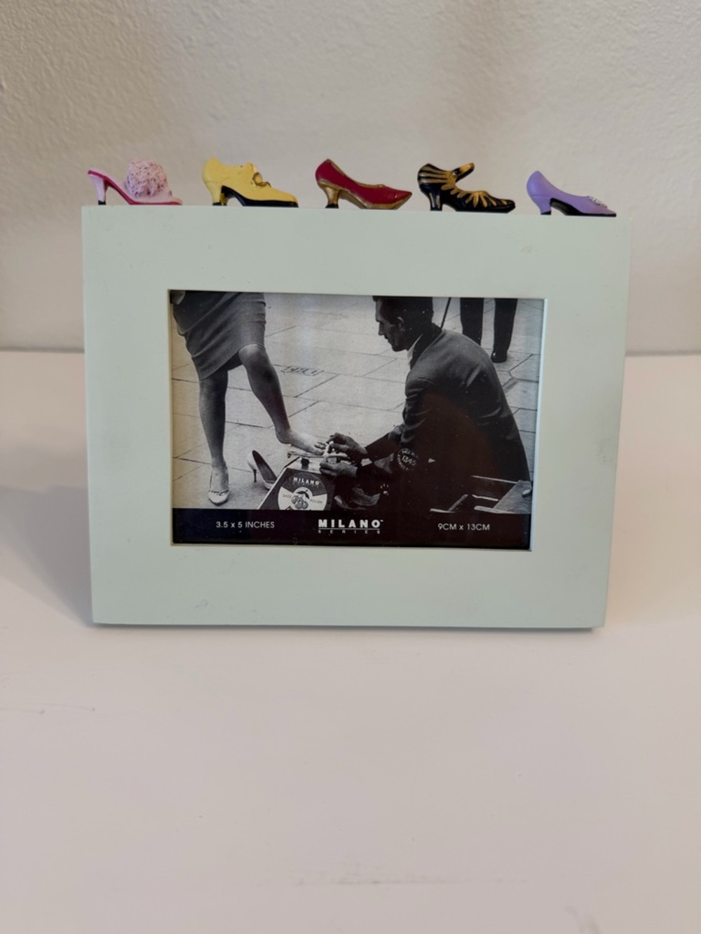 Milano photo frame. Miniature shoes on top edge. 3.5 x5 inches picture size